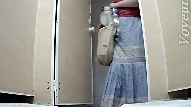 White mature lady in dress pisses in the toilet room